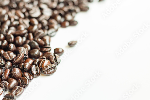 Brown roasted coffee beans on white background