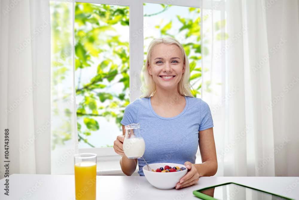 woman with milk and cornflakes eating breakfast