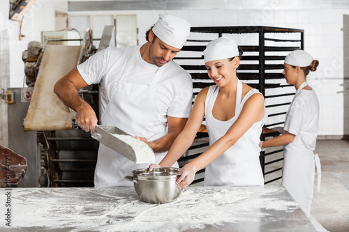 Male And Female Baker's Working Together In Bakery