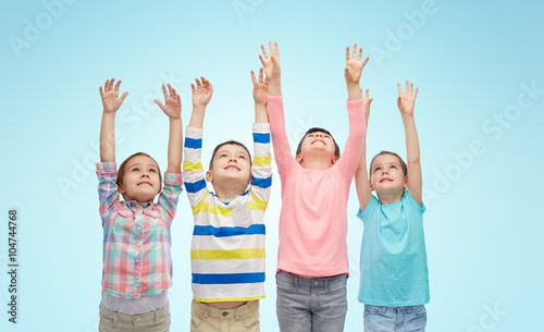 happy children celebrating victory over blue