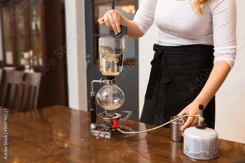 close up of woman with siphon coffee maker and pot
