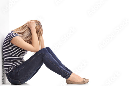 Принти на полотні Depressed blond woman sitting on floor