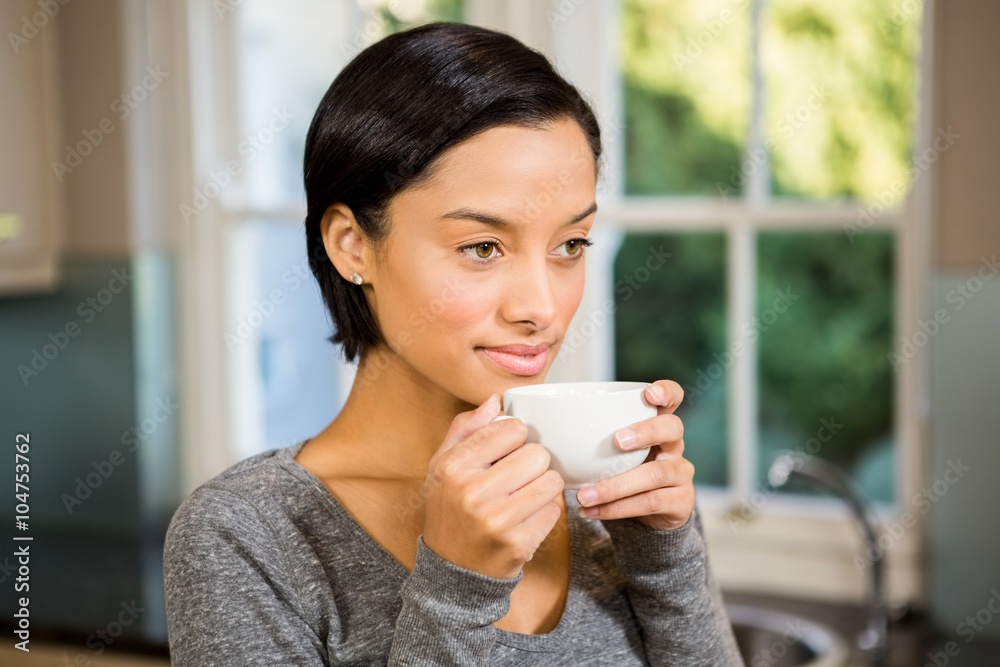 Smiling brunette holding white mug Smiling brunette holding white mug