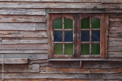 Old wooden house with colorful window 
