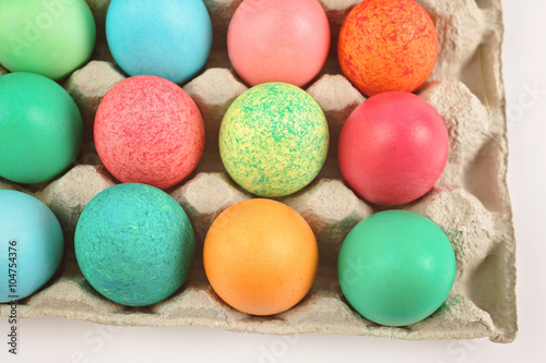 Colourful painted easter eggs in egg carton