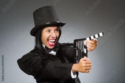 Woman with vintage hat and movie board