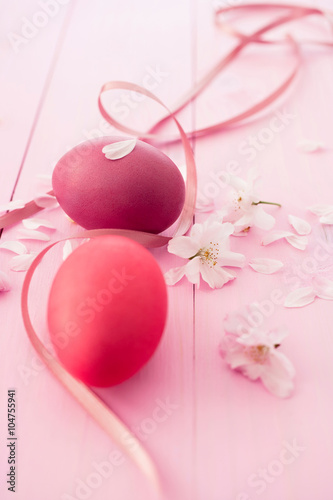 Two pink Easter eggs with cherryblossoms on pink