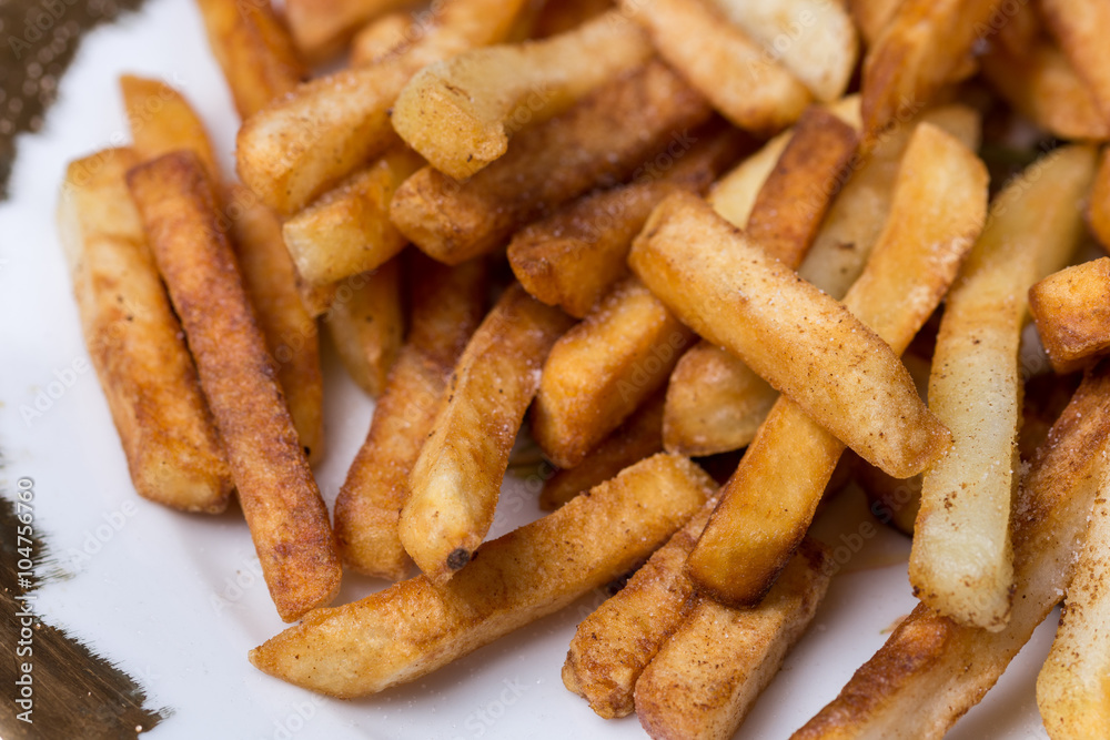 Close macro view of french fries on the plate Close macro view of french fries on the plate