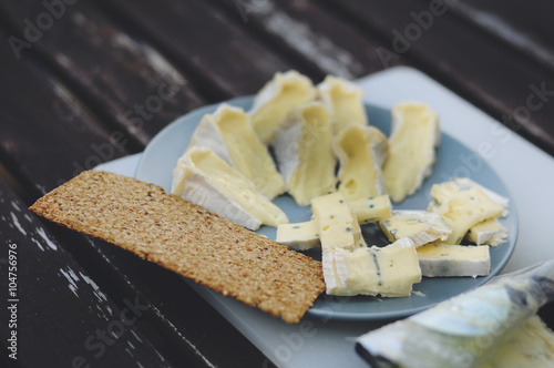 Blue cheese with crisp on wooden table marco