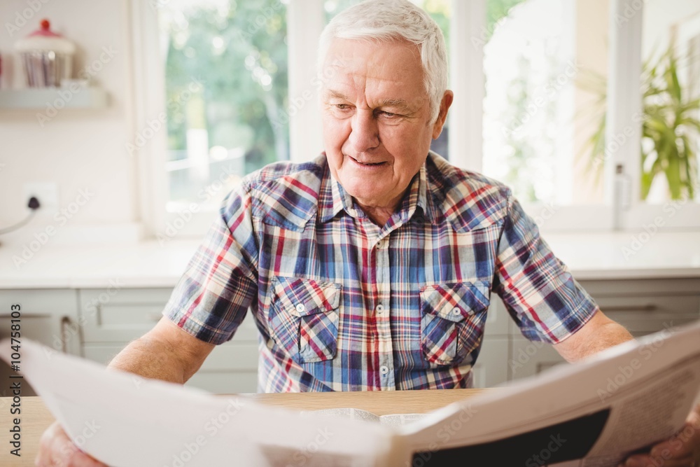 Senior man reading a newspaper Senior man reading a newspaper