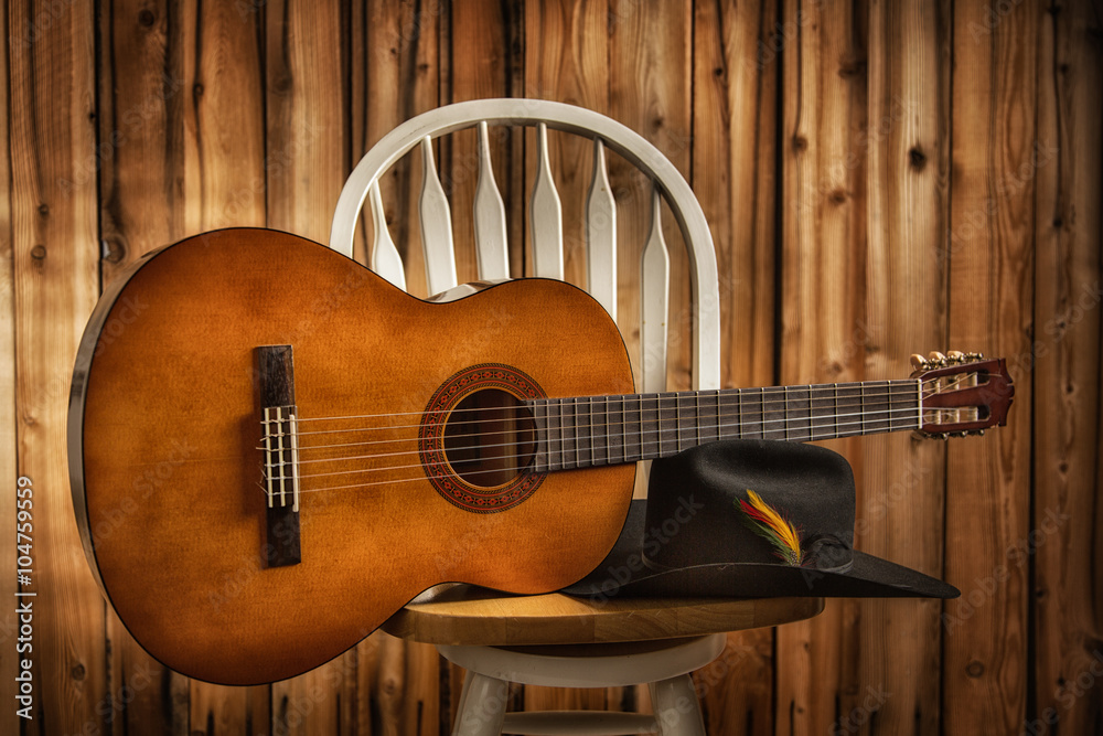 Fototapeta premium Between Sets; Guitar and Black Hat on a Stool with wood background