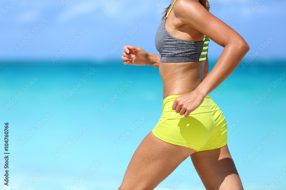 Female runner on beach with sports bra and shorts. Midsection closeup of  body of a woman athlete running with speed fast training cardio wearing neon  yellow activewear outfit. Active lifestyle. Photos
