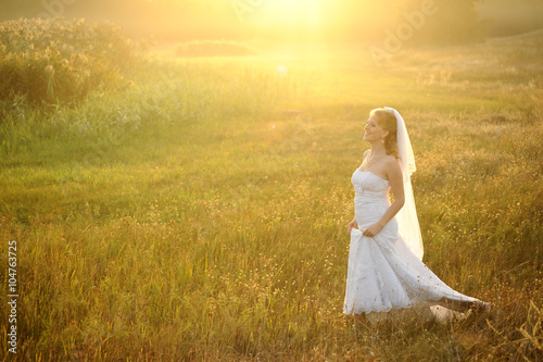 Bride Posing in the Sunlit Field