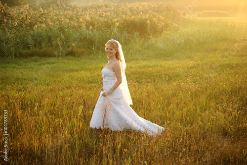 Bride Posing in the Sunlit Field