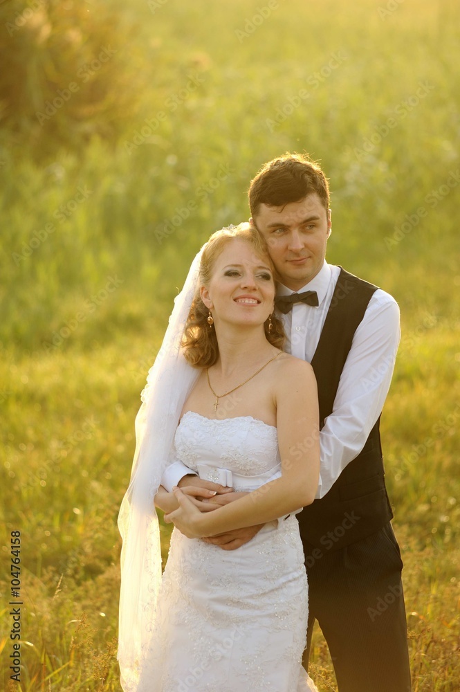 Bride and Groom Posing in the Field, filled with light Bride and Groom Posing in the Field, filled with light