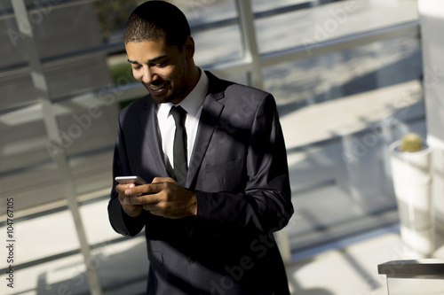 Young black man with teleph...