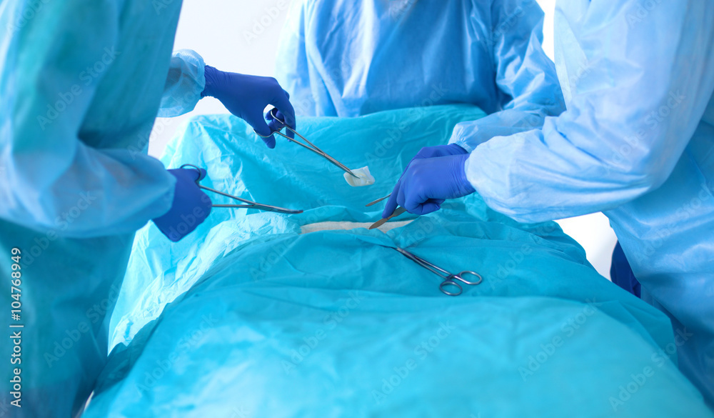 Team of surgeon in uniform perform operation on a patient at cardiac surgery clinic Team of surgeon in uniform perform operation on a patient at cardiac surgery clinic