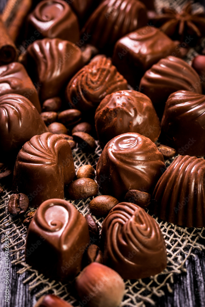 Delicious chocolate candies on wooden background Delicious chocolate candies on wooden background