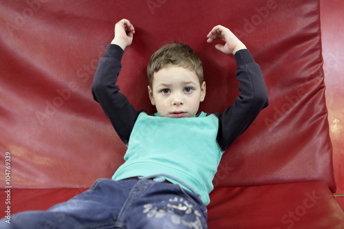 Child on a red sofa photo