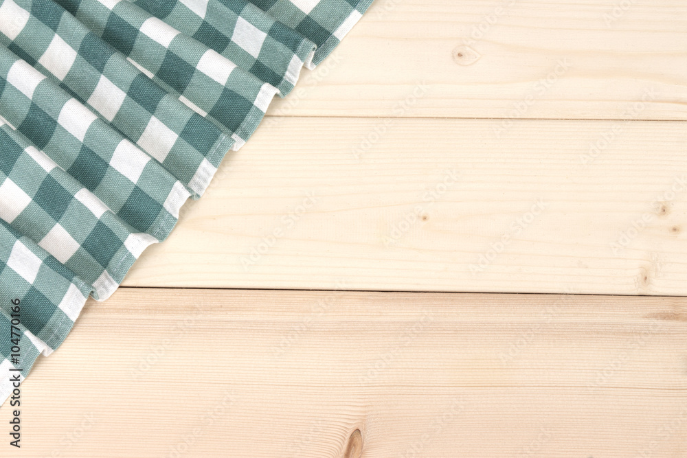 Wooden table with green picnic tablecloth and copyspace Wooden table with green picnic tablecloth and copyspace