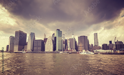 Purple old film stylized rainy clouds over Manhattan waterfront, NYC. © MaciejBledowski
