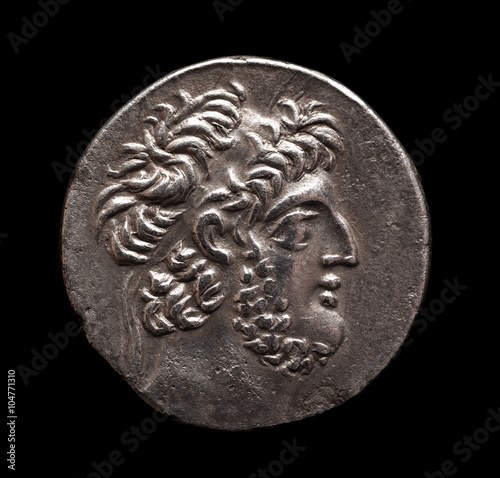 Ancient Greek silver coin on a black background