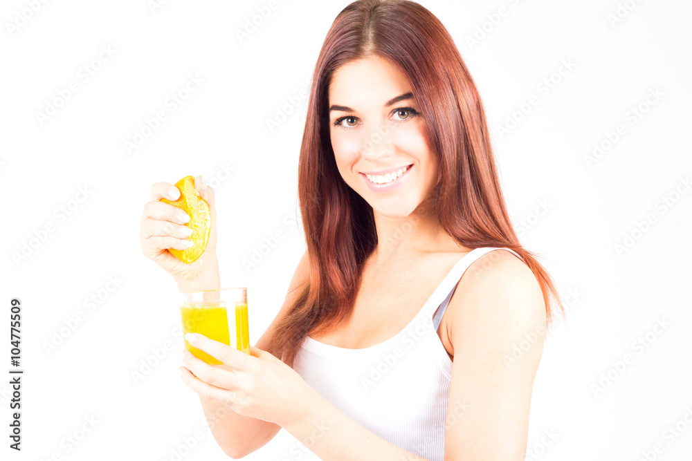 Healthy happy woman squeezes juice from orange and looking at camera. Healthy and right food. Healthy happy woman squeezes juice from orange and looking at camera. Healthy and right food.