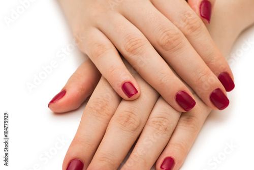 Woman hands with red nail isolated on white