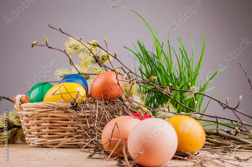 Easter eggs in the basket on a wooden table