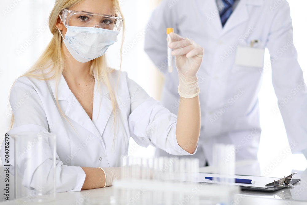 Scientific research team with clear solution in laboratory Scientific research team with clear solution in laboratory