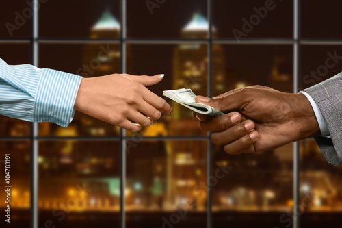 Businesswoman loans money in office.