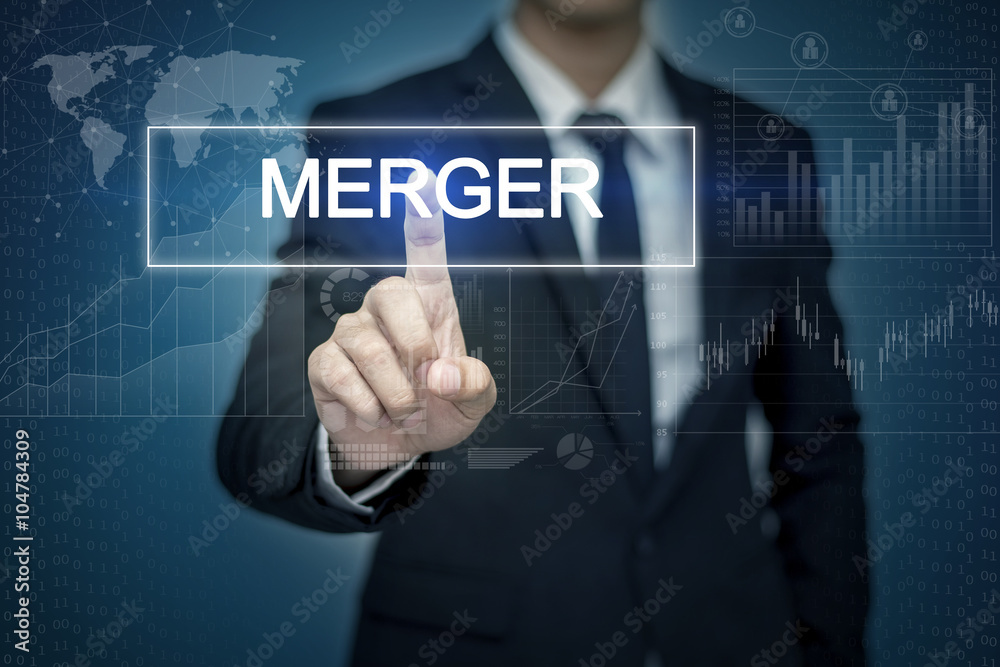 Businessman hand touching MERGER button on virtual screen Businessman hand touching MERGER button on virtual screen