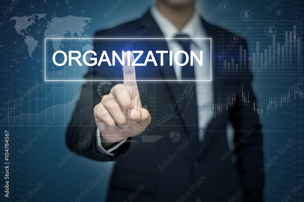 Businessman hand touching ORGANIZATION button on virtual screen Businessman hand touching ORGANIZATION button on virtual screen