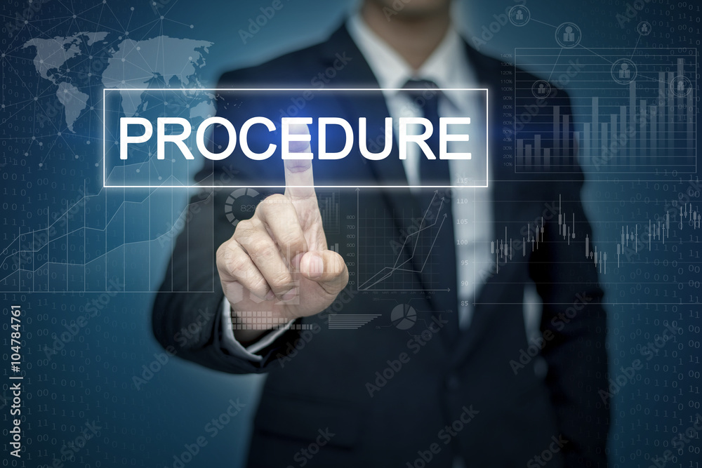 Businessman hand touching PROCEDURE button on virtual screen Businessman hand touching PROCEDURE button on virtual screen