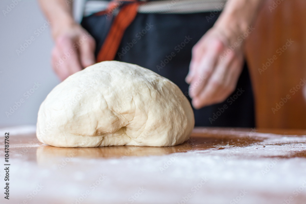 Baker makes bread on the table Baker makes bread on the table