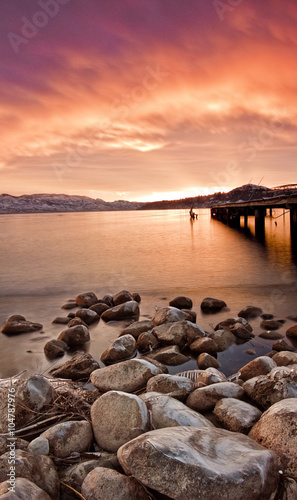 scenic sunset by shore of water in mountains