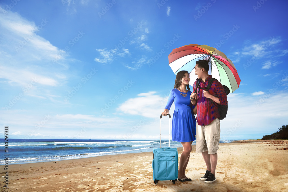 Couple asian tourist standing on the beach Couple asian tourist standing on the beach