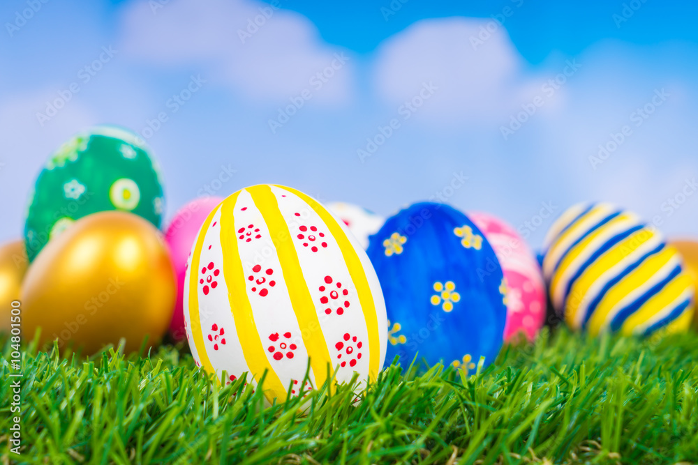Easter Eggs on Fresh Green Grass over blue sky