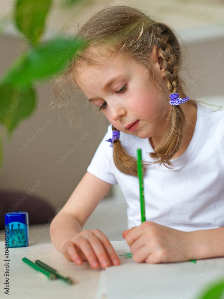 Little girl drawing with pencil at home. Little girl drawing with pencil at home.