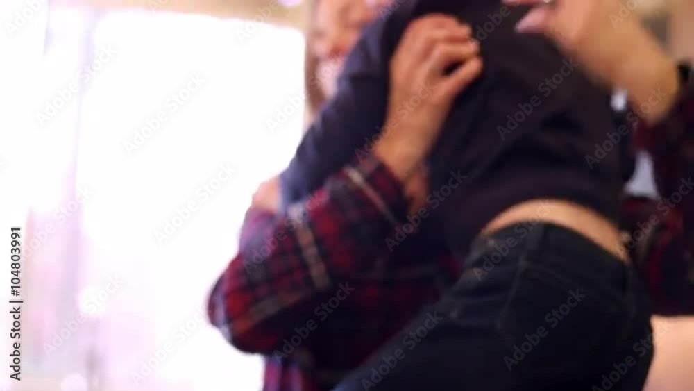 A mother picks her daughter up in the kitchen and holds her, slow motion A mother picks her daughter up in the kitchen and holds her, slow motion