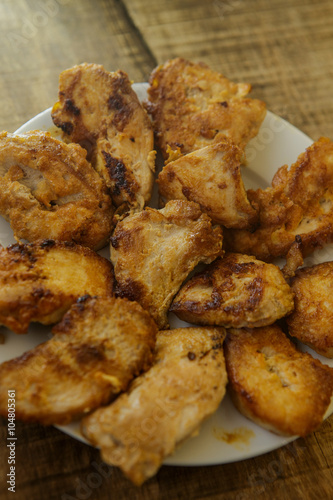 Top View Fried Pieces of Chicken Lying on White Plate