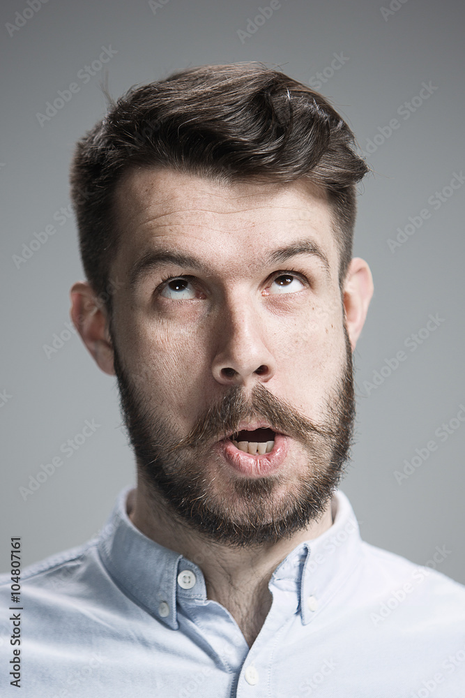 Man is looking reminiscing. Over gray background Man is looking reminiscing. Over gray background