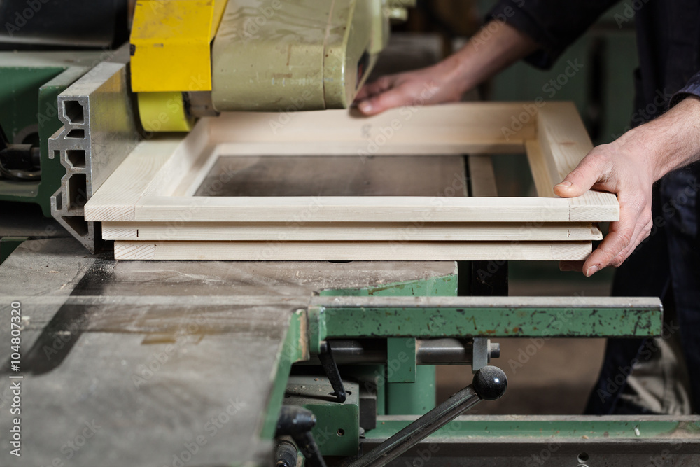 Carpenter's hands cutting wooden window frame Carpenter's hands cutting wooden window frame