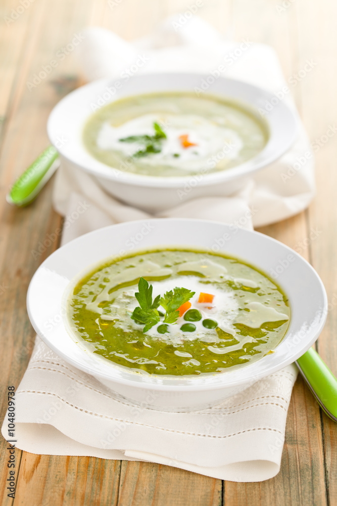 Green pea soup in bowls.