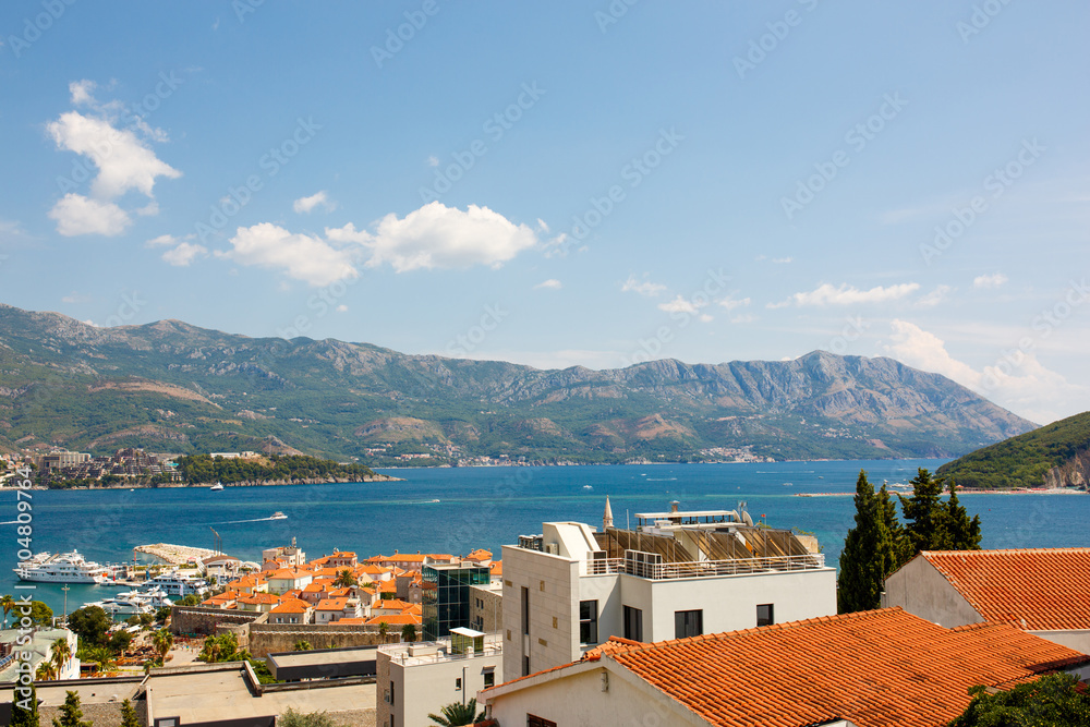 Panoramic view of Old town Budva: Ancient walls and red tiled roof.