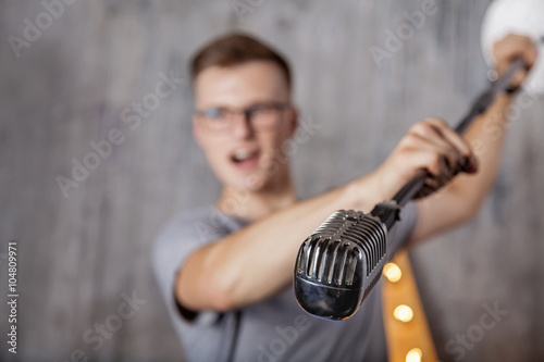 Young man with vintage microphone