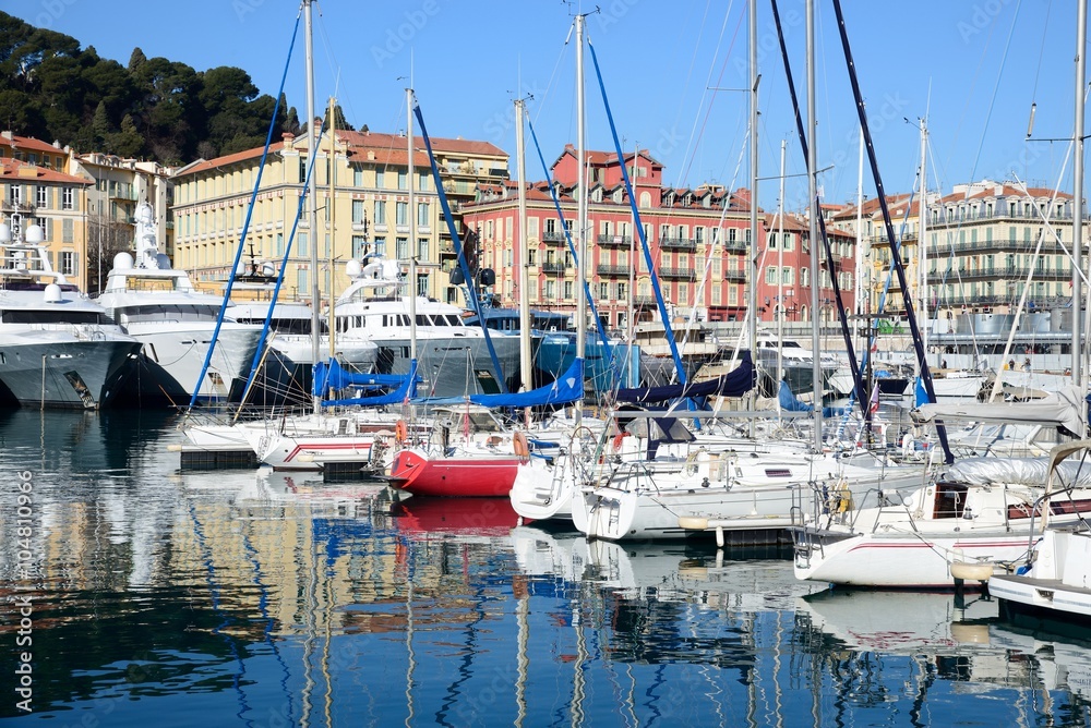 Boats and yachts moored in the port of Nice in a sunny day