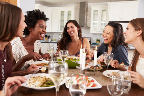 Group Of Female Friends Enjoying Dinner Party At Home