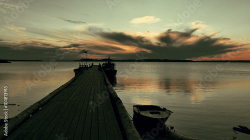 Tranquil Sunrise on Lake With Wooden Pier photo