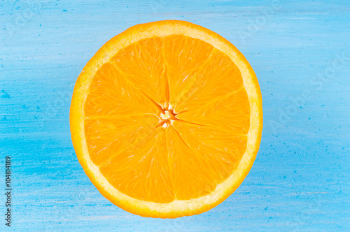 orange slice on blue wooden background